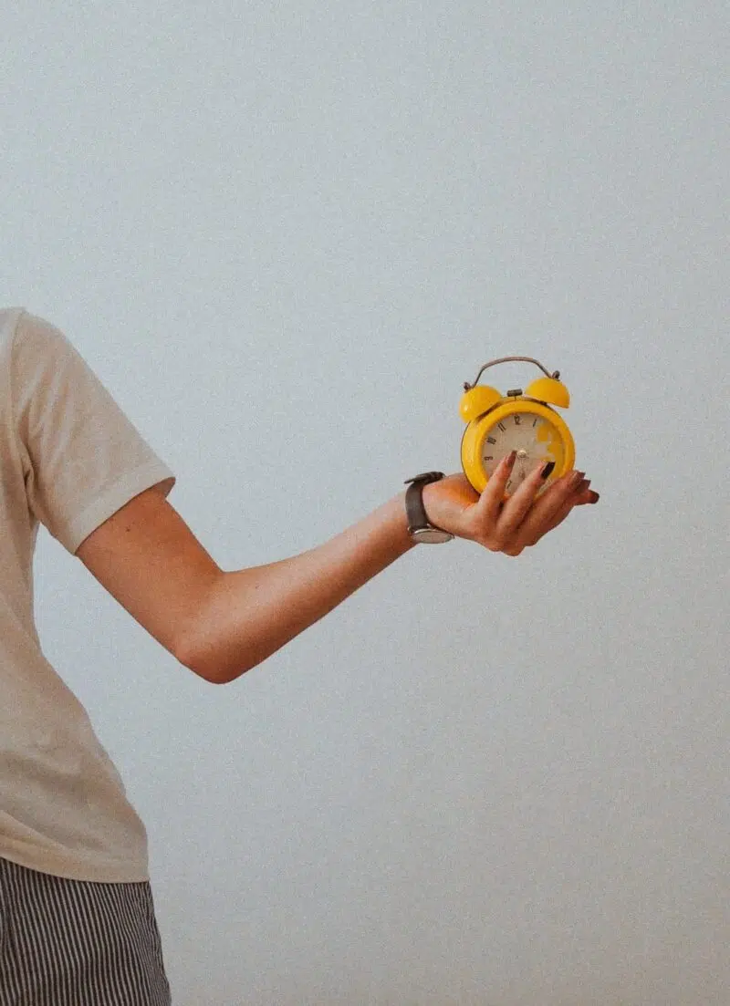 Woman Holding An Alarm Clock