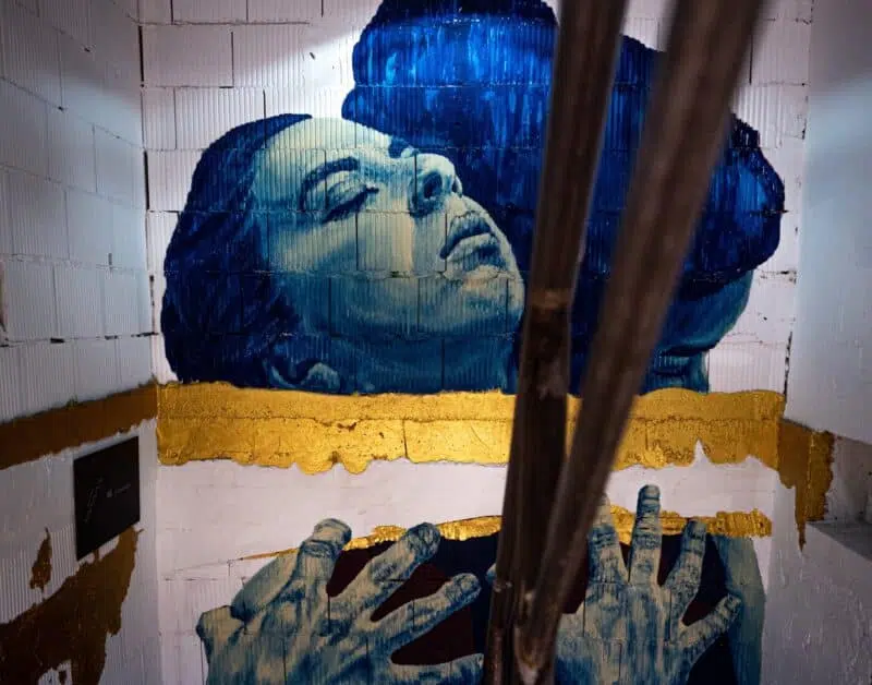 Painting Of A Womans Face On A Stairwell Wall